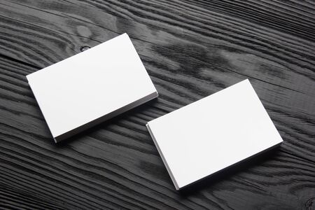 Business card blank on wooden background. Corporate Stationery, Branding Mock-up. Creative designer desk. Flat lay. Copy space for textの写真素材