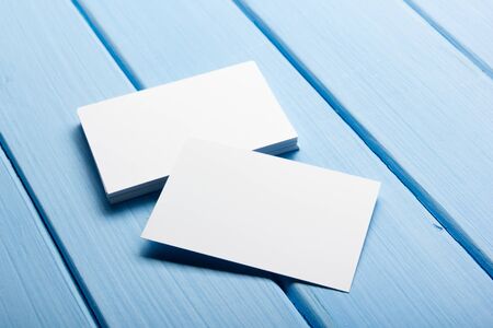 Business card blank on wooden background. Corporate Stationery, Branding Mock-up. Creative designer desk. Flat lay. Copy space for text.の写真素材
