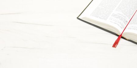 Composition with vintage old hardback books, diary, fanned pages on wooden deck table and red background. Books stacking. Back to school. Copy Space. Education backgroundの写真素材