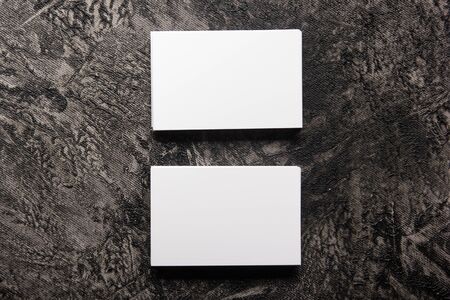 Business card blank on wooden background. Corporate Stationery, Branding Mock-up. Creative designer desk. Flat lay. Copy space for textの写真素材