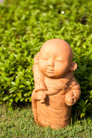 Monk statue in the gardenの写真素材