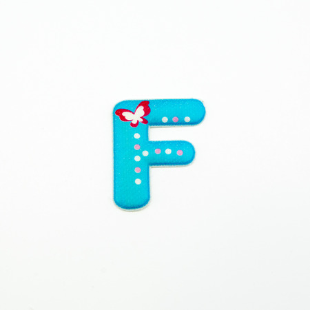 Letter F plastic sticker isolated on white backgroundの写真素材
