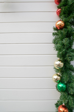 Decorated Christmas tree on wooden wall backgroundの写真素材