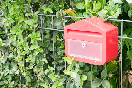 plastic Thai mailbox on a steel fenceの写真素材