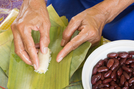 steamed sticky rice with banana wrapped in banana leavesの写真素材
