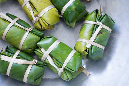 steamed sticky rice with banana wrapped in banana leavesの写真素材