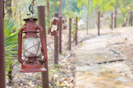 metal lanterns suspended in gardenの写真素材