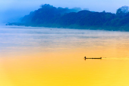 The Thai local fisherman was fishing in the Mekong River at dawn.の写真素材