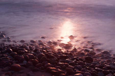 Baltic Sea coast sunset hour. The sea washes the stonesの写真素材