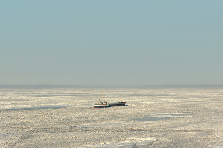 Sea ice stranded ship. Waiting icebreaker to free them from the iceの写真素材