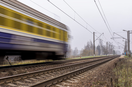 Electric passenger train traveling on the railroad tracks. Remoteness visible to passengers who will train.の写真素材