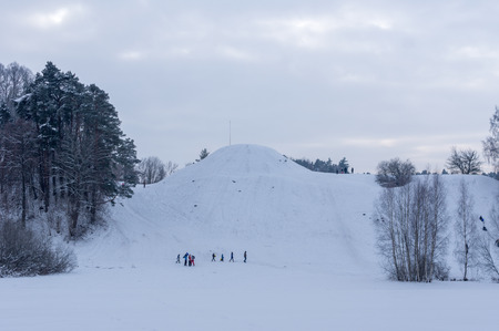 Winter holiday family actively resting on a hill