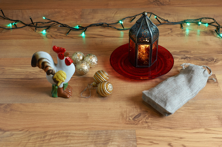Red lantern with a rooster, tree decorations and Christmas lightsの写真素材