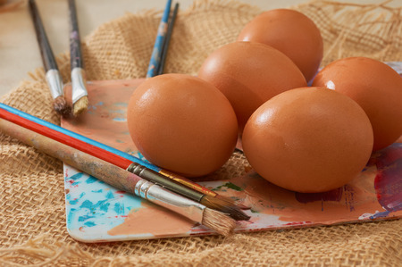 Painting Easter eggs: Brush on colors with eggs in the background. The color paletteの写真素材