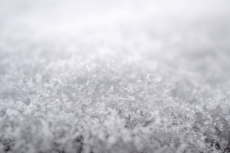 close-up photograph of a snow texture, individual flakes are visible, macro photography taken from...