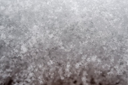 close-up photograph of a snow texture, individual flakes are visible, macro photography taken from different angles and differentiated focusの写真素材