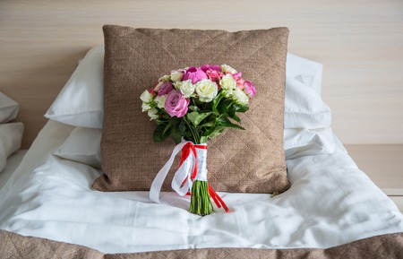 Wedding bouquet on a pillow room hotelの写真素材