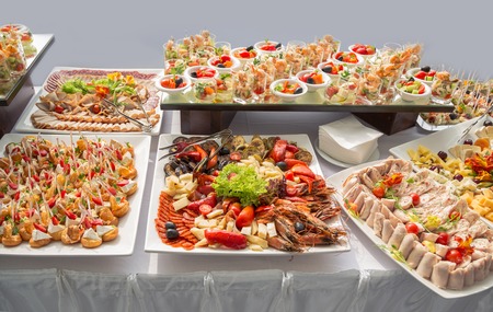 Banquet Table in restaurant served with different meals. Ready for wedding reception.の写真素材