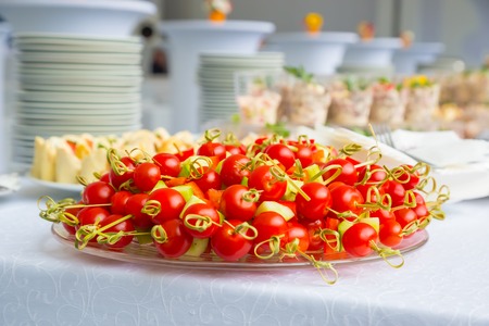 red cherry tomatoes on a plate. Buffet tableの写真素材