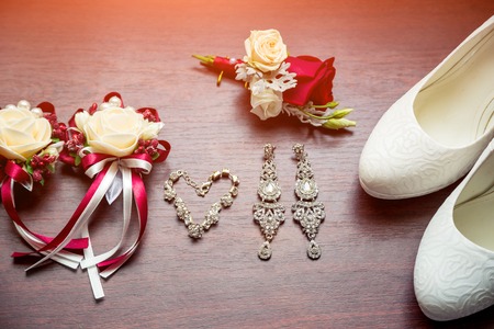Wedding details. Bouquet and accessories of bride and groom. Wedding red decorations on tableの写真素材