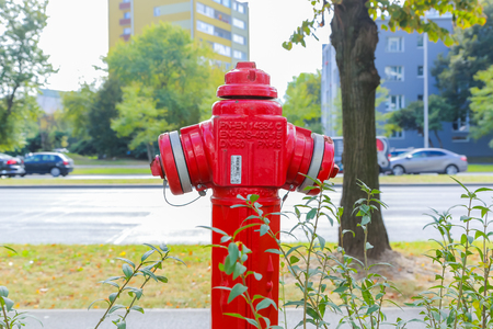 A red fire hydrant in a city setting. POLAND. WARSAW 12.09.2016