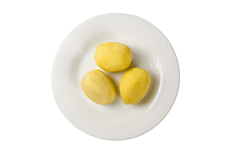 Three potatoes on a plate isolateの写真素材