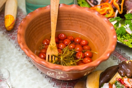 Pickled tomatoes on a plate. Beautiful and tasty food on a plateの写真素材