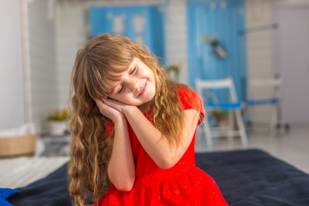 Little baby girl closeup shows different emotionsの写真素材