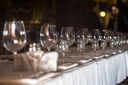 catering table set service with silverware, napkin and glass at restaurant before partyの写真素材