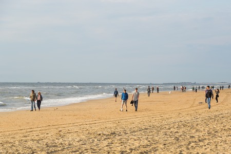 Zandvoort, Netherlands June 10. 2017: Tourists are walking along the sea line. Zandvoort is a main sea resort and touristic center.のeditorial素材