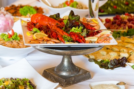 Cooked cancer at a banquet table for a wedding. Snack for beer. Big plate of tasty boiled crawfish closeup on wooden table, seafood dinner, nobodyの写真素材