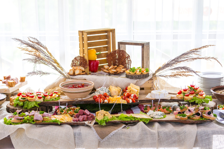 Banquet Table in restaurant served with different meals.の写真素材