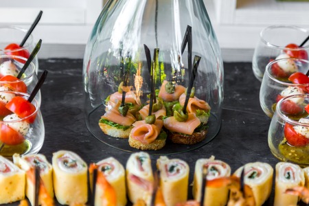 Cold snacks under glass. Corporate and banquet table