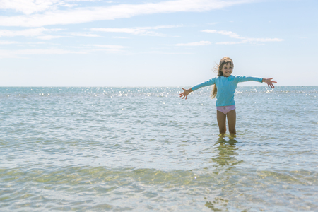 A little girl is enjoying sea waterの写真素材