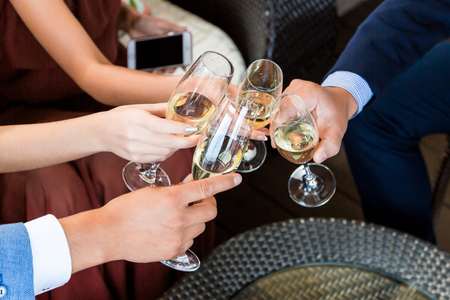 Hands holding glasses and toasting, happy festive moment, luxury celebration concept.の写真素材