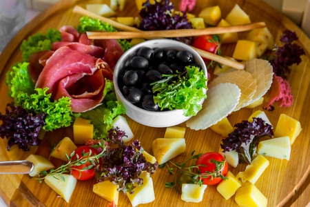 Cutting of cheese on a banquet table, beautifully served banquet tableの写真素材