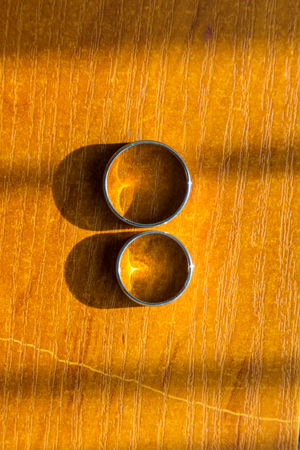 Wedding rings look up on a wooden backgroundの写真素材