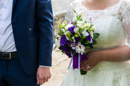 the bride holding the wedding bouquetの写真素材