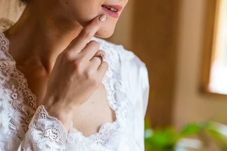 Young girl seductively holds her finger around her faceの写真素材