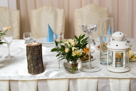 Beautiful wedding table for newlyweds is illuminated by candlesの写真素材