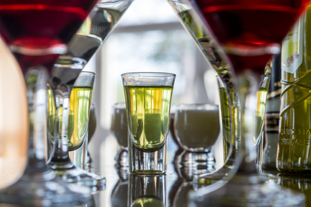 Several glasses of the famous Martini cocktail stand on a bar tableの写真素材