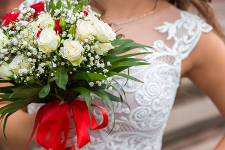 The bride and two brides hold their wedding bouquets, showing them.の写真素材