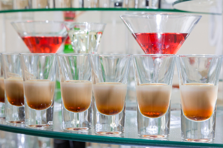 Alcoholic cocktails on a glass surface, banquet table.の写真素材