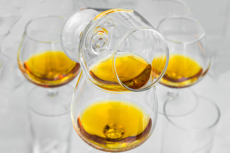 Glasses are filled with whiskey on the tableの写真素材