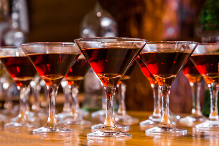 Alcoholic cocktails on a glass surface, banquet table.の写真素材