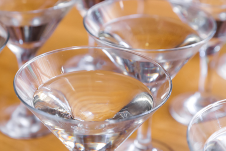 Alcoholic cocktails on a glass surface, banquet table.の写真素材