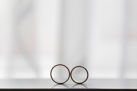 Two wedding rings next to the windowの写真素材
