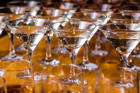 Glasses are filled with whiskey on the tableの写真素材