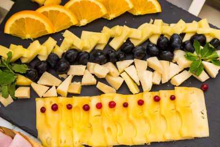 Authentic buffet, assorted fresh fruits, berries and citrus fruits. Morning atmospheric lighting, fashionable trendy spot soft focus. Preparation for design creative menu.の写真素材