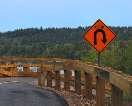 paved bicycle path in city park with slow signの写真素材